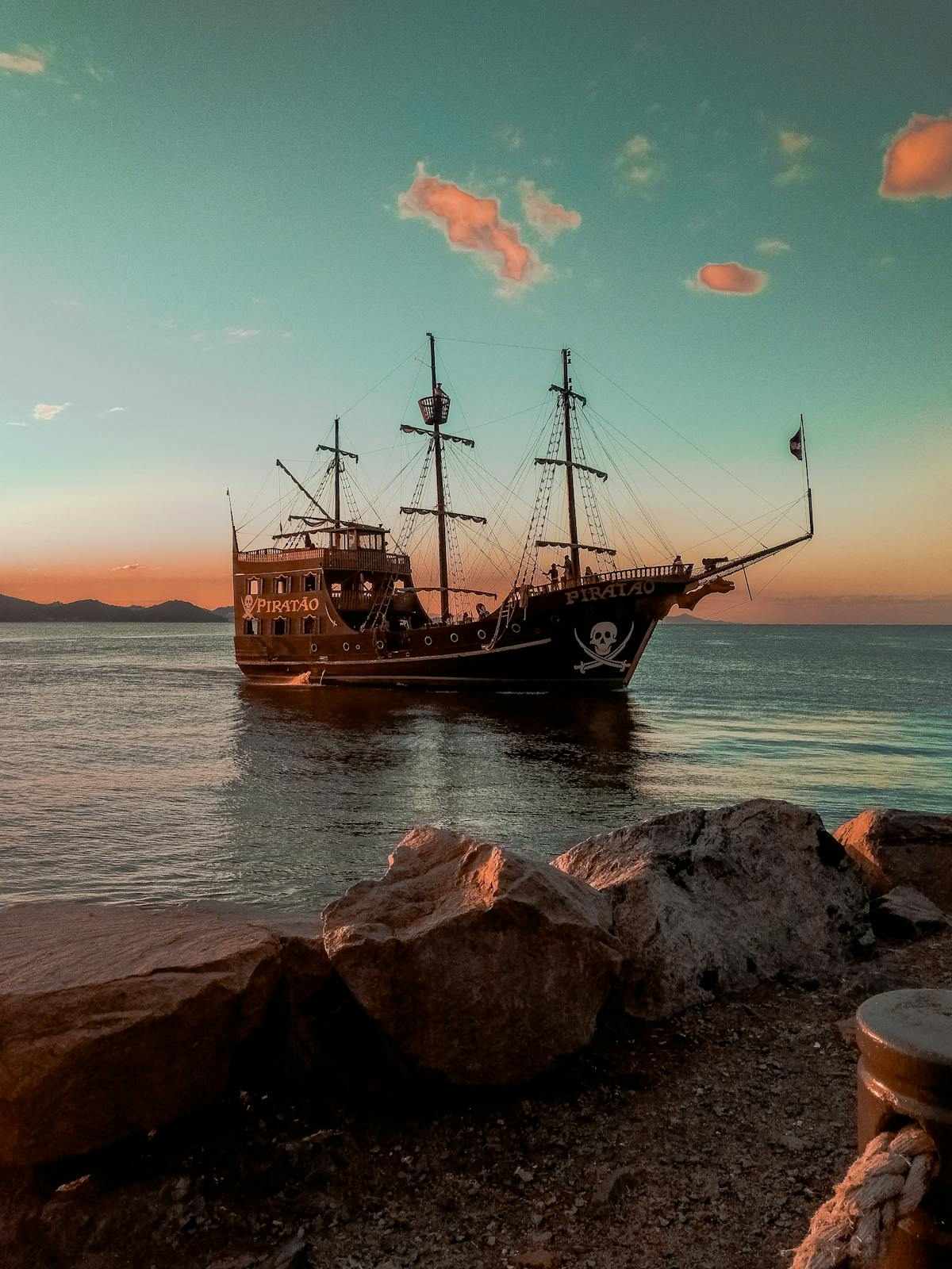 Pirate ship sailing into sunset